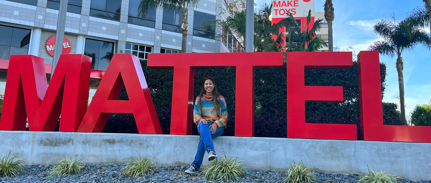 Alumna Kristen Sanzari in front of Mattel sign