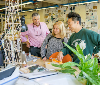 Cal Poly Architecture Professor Thomas Fowler and architecture students Emma Entress and John Kim Jr. review conceptual work in a third-year design studio.