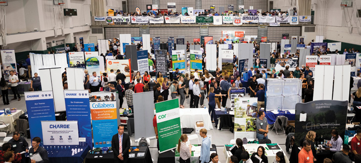 aerial view of career fair in the two-story recreation center, full of tables and banners