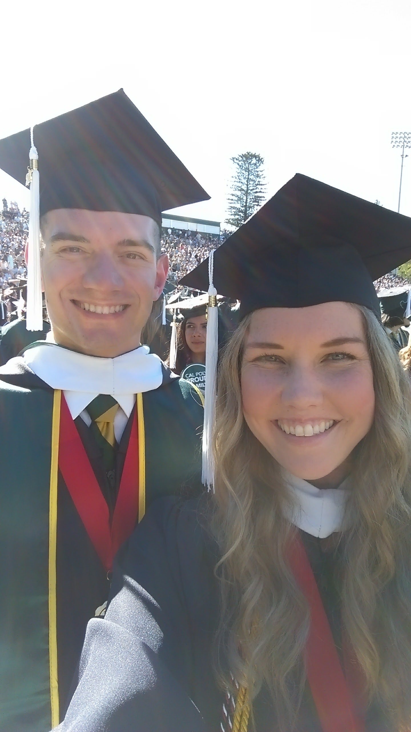 Borrelli and a classmate smiling at their graduation ceremony