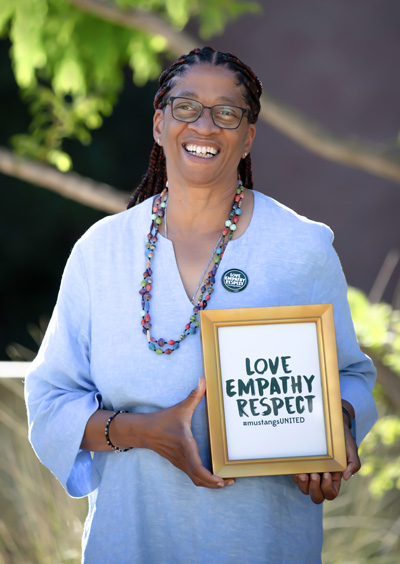 Camille O'Bryant holding a Love, Empathy, Respect sign