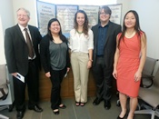 Graduate Students taking picture with poster