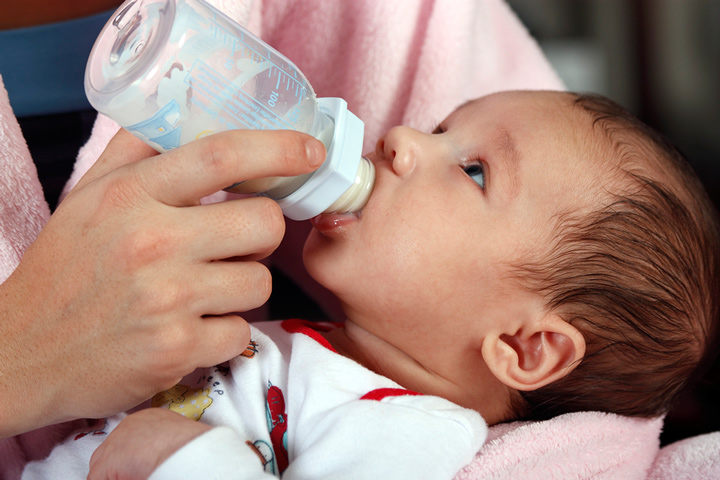 Baby boy bottle feeding