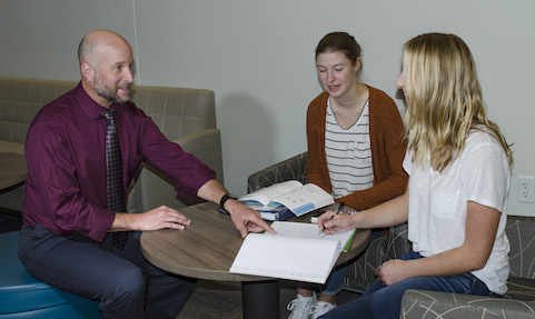 Wendt checks in with students doing homework in the Baker Center.