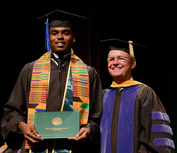 Dean Bailey with a student at the annual Black Commencement