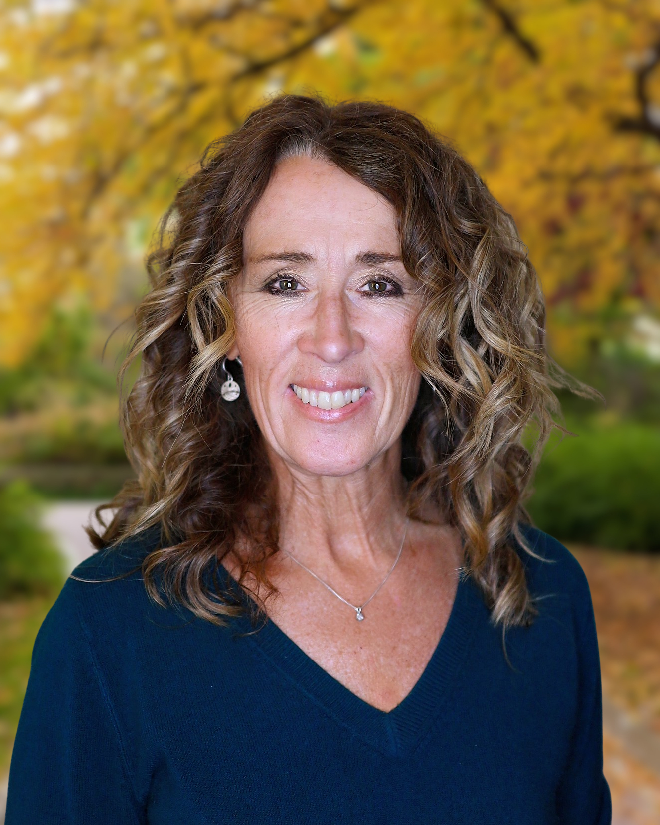 Head shot of advisor Kristi Weddige in front of vine background