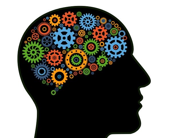 Silhouette of head with colorful cogwheels