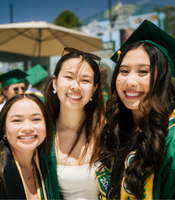 Three people in graduation gowns