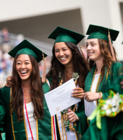 Three people in graduation caps and gowns