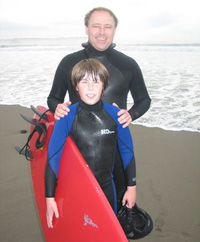 Dr. Hendricks posing with his son at the beach