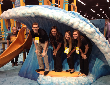 Quiz Bowl team poses under a wave machine