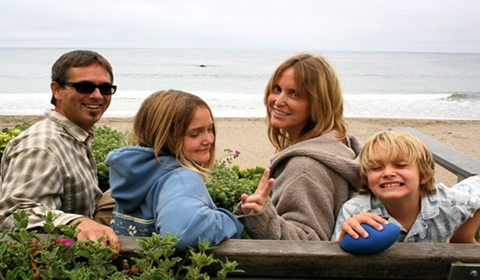 Jodi and family pose with the Pacific Ocean in the background