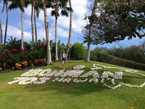 Blosser poses next to IRONMAN Hawaii sign