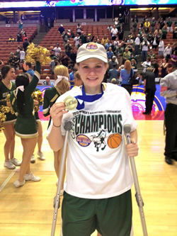 Kayla poses on the court with her NCAA medal