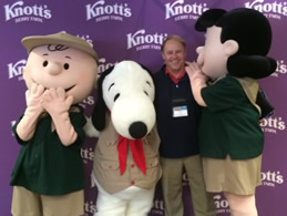 Dr. Hendricks poses with Peanuts characters at the Cal Travel Summit