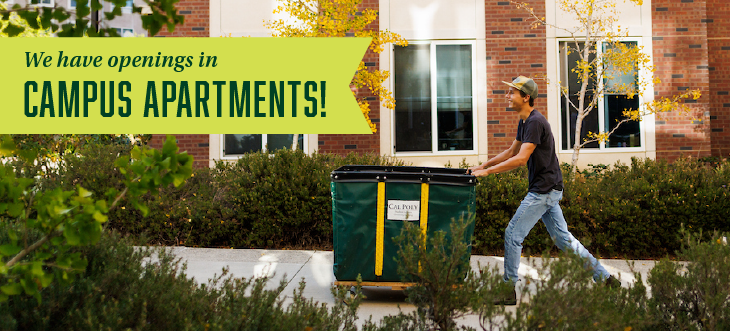 Student rolling move-in cart outside of Poly Canyon Village apartments