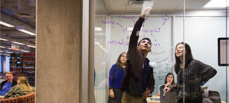 Students utilizing one of the group study spaces in the library
