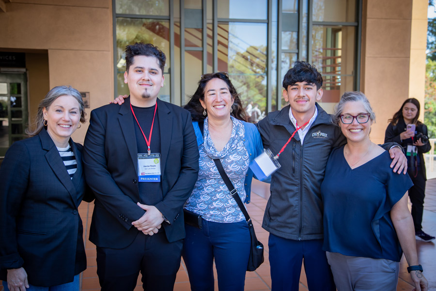 Students pose with professors and the Cal Poly director of the Office of Student Research