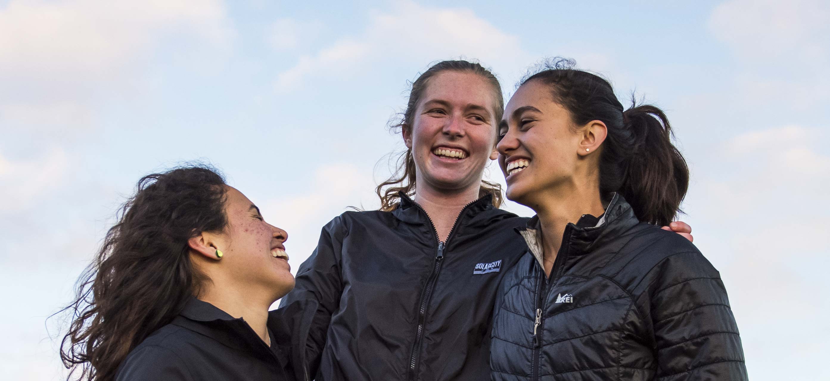 stock image. three female students share moment of joy.