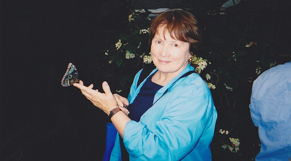 Professor Emeritus Jean Marie McDill hold a butterfly