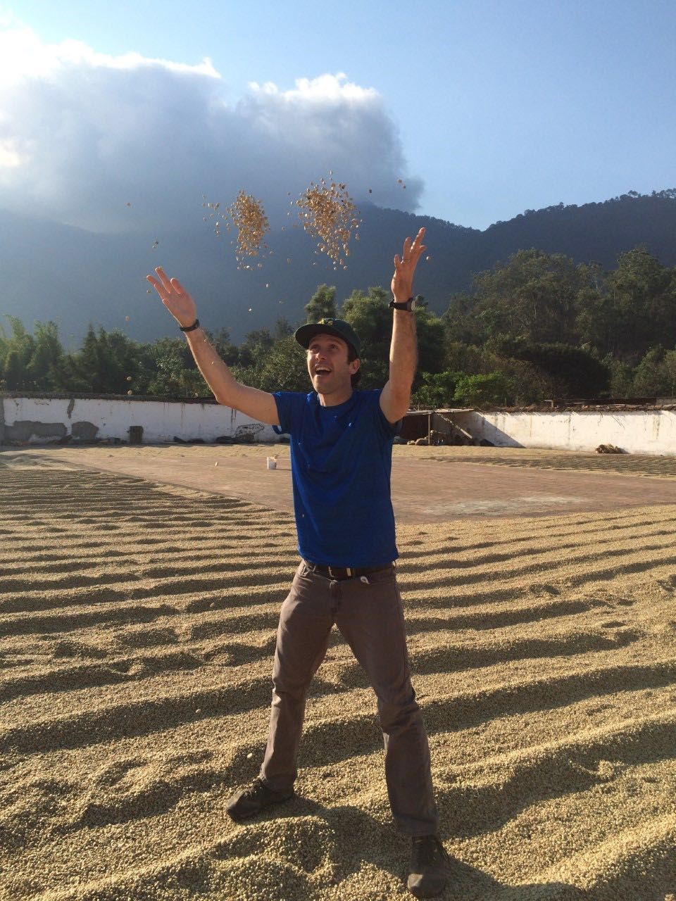 Nicholas Babin throwing grain in a field