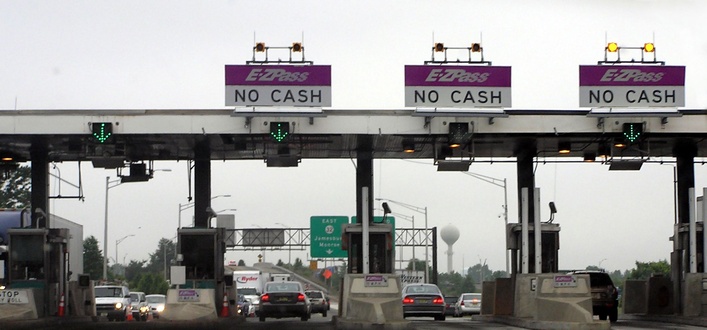 Image of a tollbooth and cars, showing how tollbooths equipped for automated toll collection.