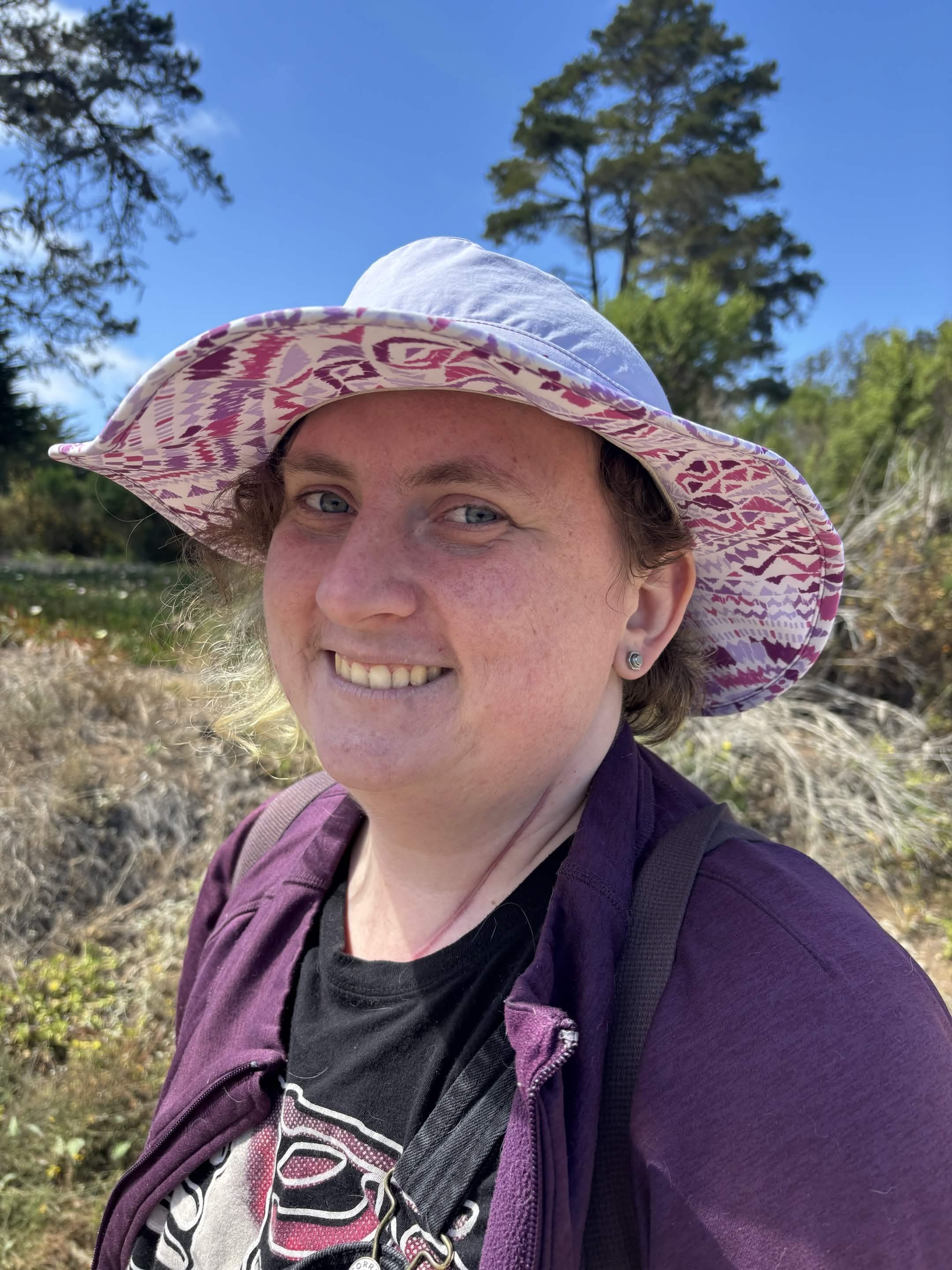 Picture of a white person wearing a purple hat