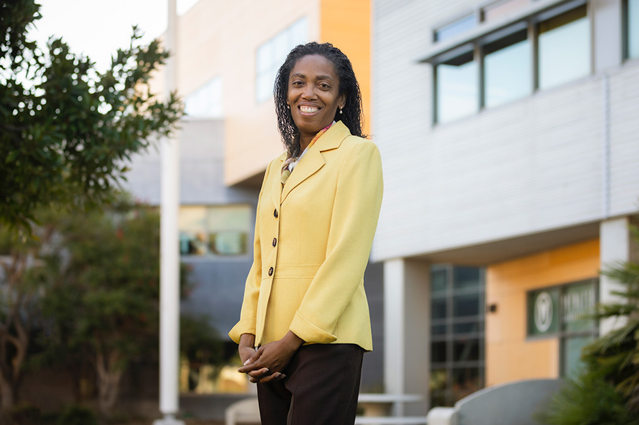 Provost Cynthia Jackson-Elmoore smiling in front of science building