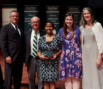 Soma Roy with her award and President Armstrong, Dean Bailey, a student, and Provost Enz Finken