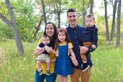 Helen Totterdell with her husband and three children in the woods