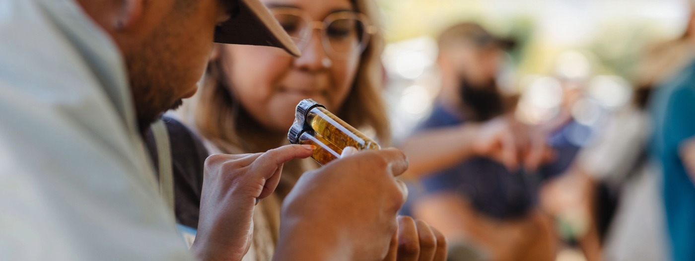 Field Day attendees examine an item during a hands-on activity.