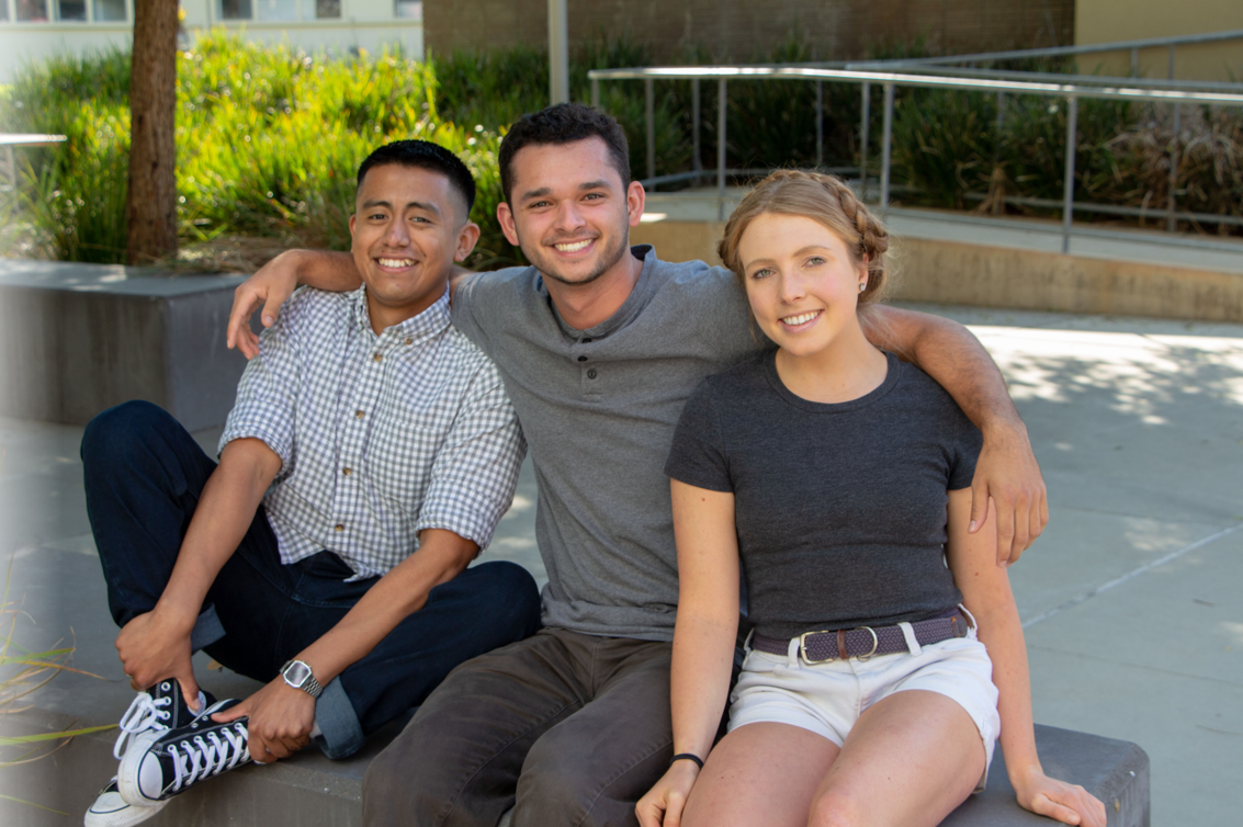 Jorge, Erik, Aubrey sitting on a bench 