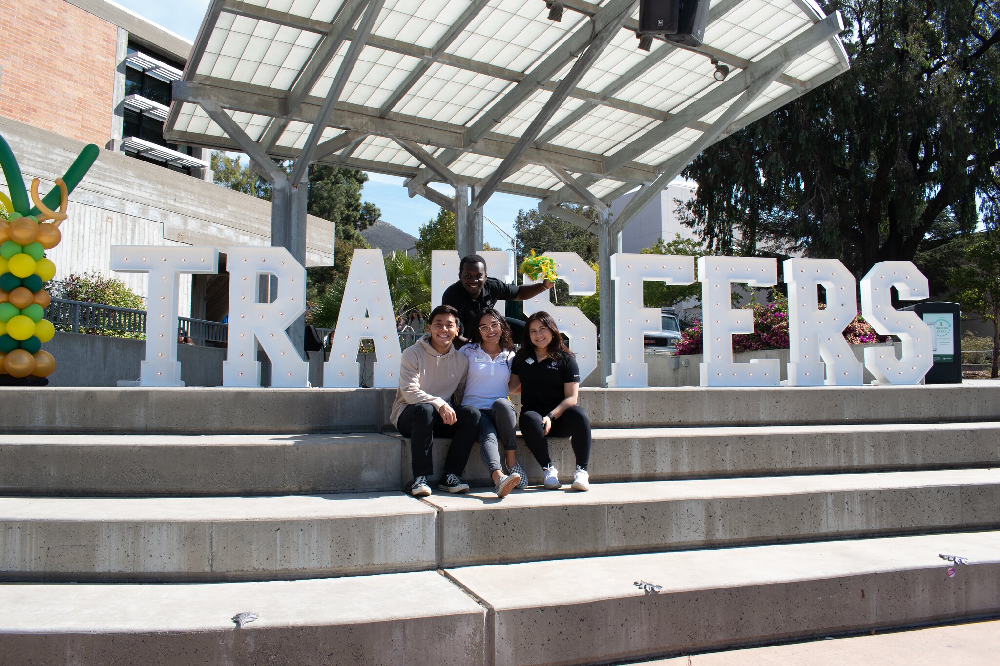 Transfer marque letters with 4 students in front