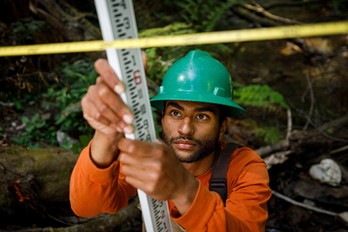 A student in the watershed management program at Swanton Pacific Ranch conducts a survey.