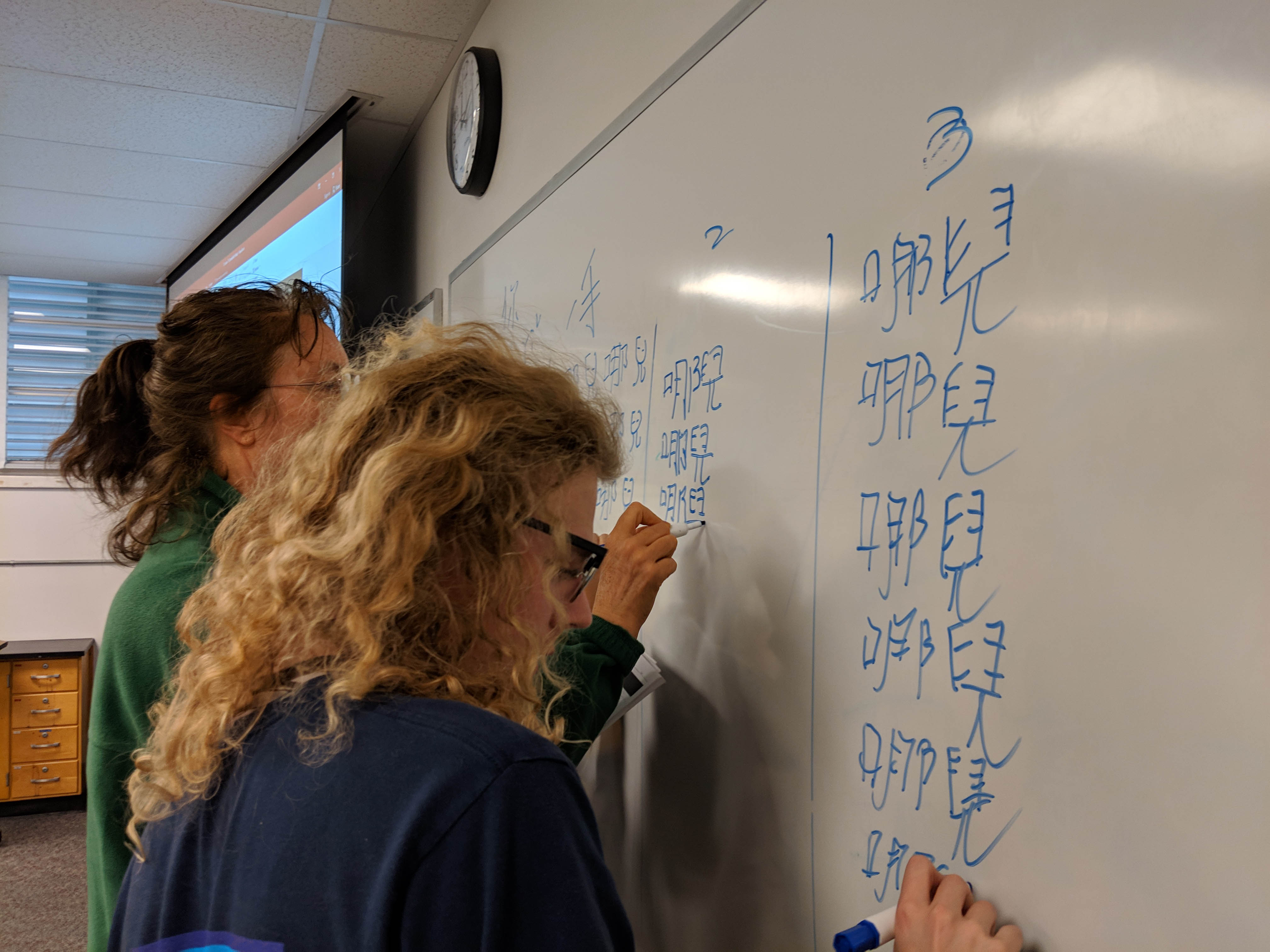 students writing Chinese characters